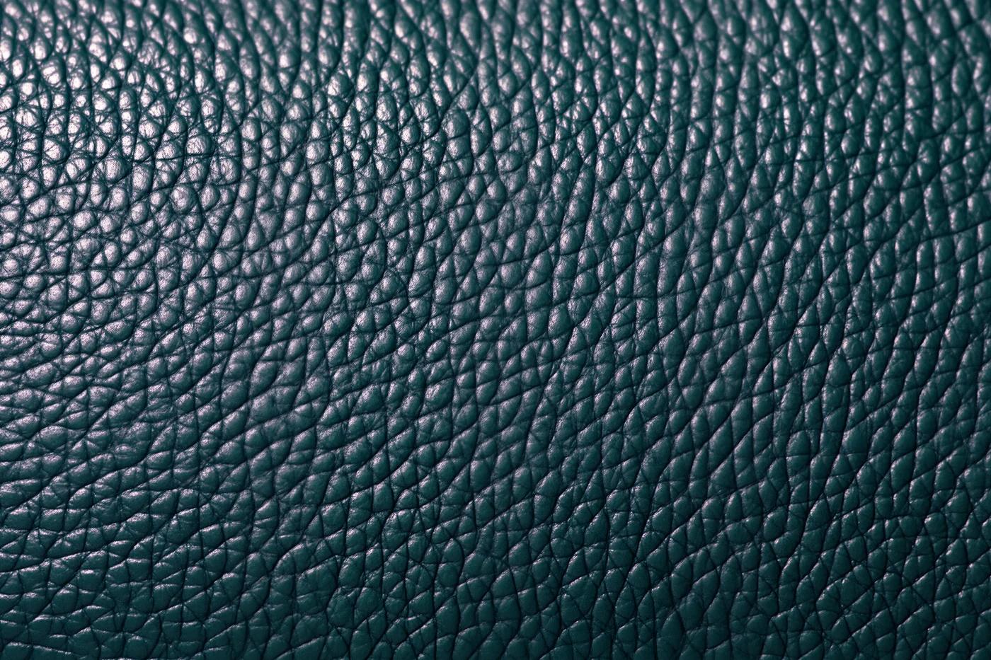 Close-up of corrected-grain leather with a uniform stamped pattern and sprayed finish